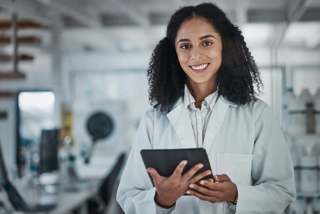 Science, research and portrait of woman with tablet and smile in laboratory, internet, medical data search online. Healthcare, pharmaceutical innovation and happy scientist with technology at work.
